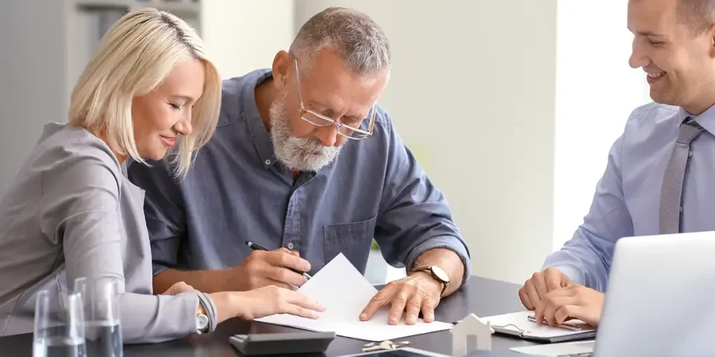 old man and his daughter signing a co-signing loan